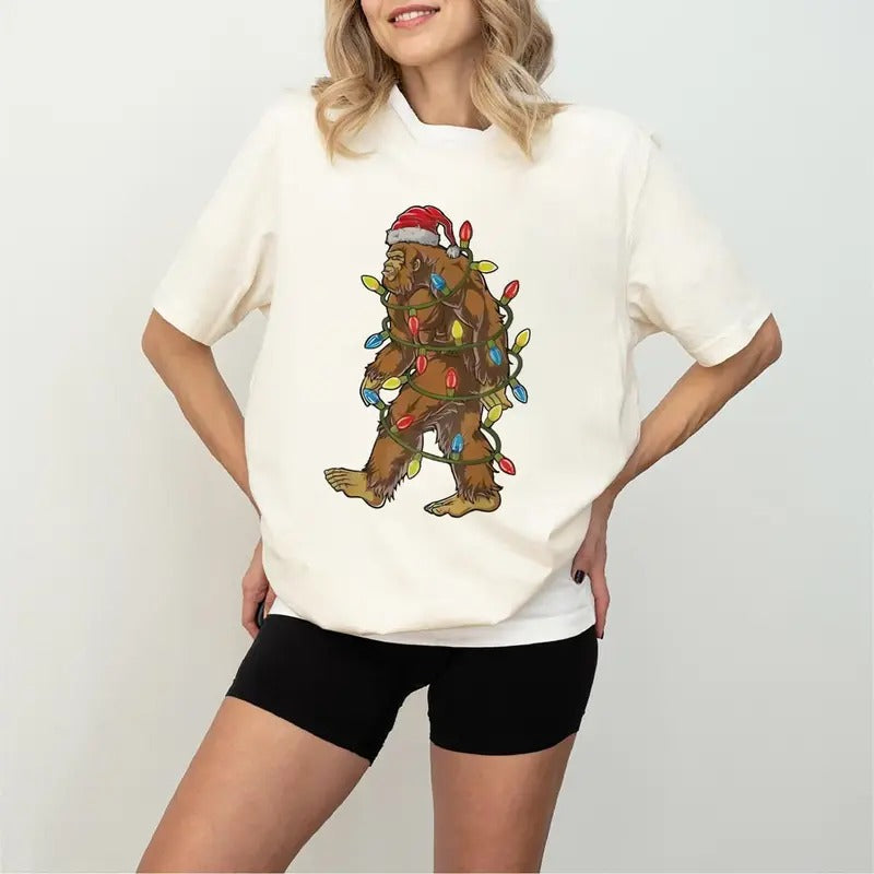 Festive Christmas Bigfoot Unisex t-shirt, Funny Santa Bigfoot Christmas Shirt, T-Shirt in all sizes and all colors for...