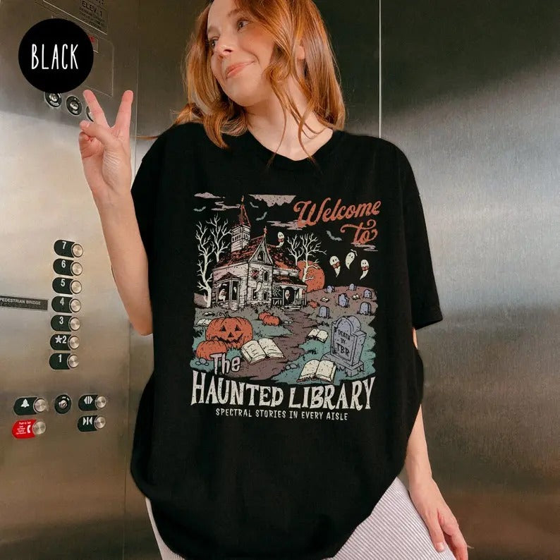 Haunted Library Shirt for Book Lover, Funny Halloween Librarian Graphic Tee, Bookish Spooky Crewneck Reading Ghost...