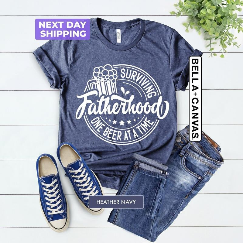 Surviving Fatherhood One Beer At A Time TShirt, Funny Fatherhood Shirt, FatherS Day Tee, Skeleton Dad Tee, Husband Gift,...