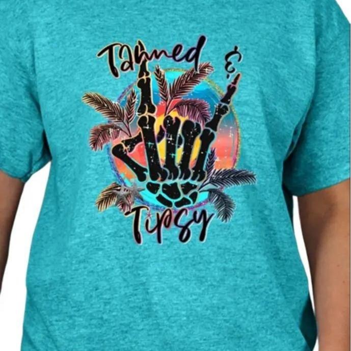 Tanned & Tipsy T-shirt - Casual Crewneck T-Shirt with Graphic Design Featuring Palm Trees and "Tanned & Tipsy" Text...