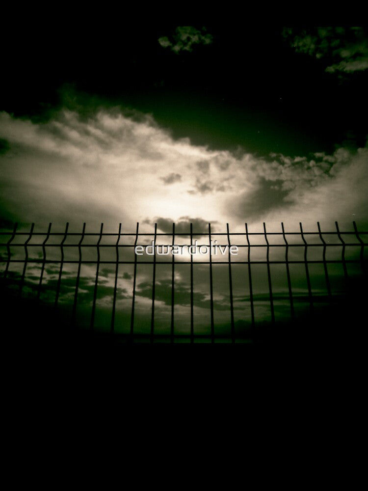 Fence against sky and clouds black and white analog 35mm silver gelatin black and white film photographs by edwardolive